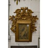 A religious icon in a decorative gilt frame.