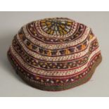 AN UZBEK SUZANI EMBROIDERED SKULL CAP.