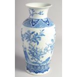 A CHINESE BLUE AND WHITE PORCELAIN VASE, the body finely painted with birds and native flora, the