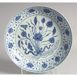 A LARGE CHINESE BLUE AND WHITE PORCELAIN CHARGER decorated with central floral spray, further