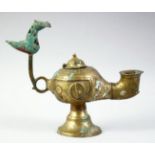 AN ISLAMIC GILT BRONZE OIL LAMP, with lid and zoomorphic finial, 20cm long.