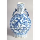A SMALL CHINESE BLUE AND WHITE PORCELAIN MOON FLASK, painted with central panel depicting dragon and