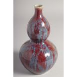 A SMALL CHINESE FLAMBE-TYPE GLAZE DOUBLE GOURD VASE, 19cm high.