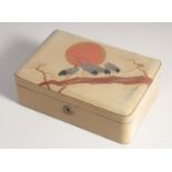 A JAPANESE LACQUERED WOOD BOX, the hinged lid decorated with cranes on a branch in the sunset with