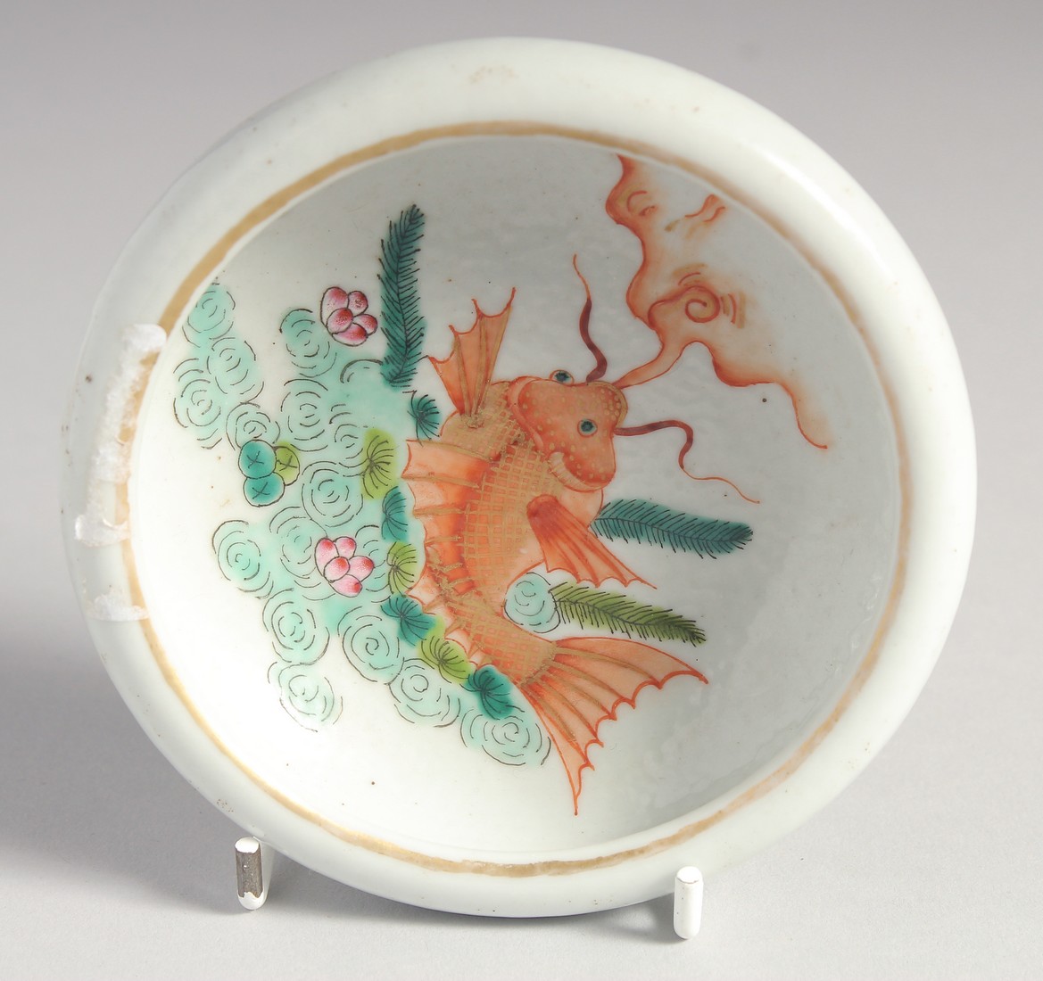 A SMALL CHINESE CORAL RED AND WHITE PORCELAIN BRUSH WASHER, the interior centre painted with a