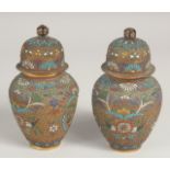 A PAIR OF CHINESE CLOISONNE JARS AND COVERS, decorated with various enamelled wire work floral