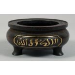 A CHINESE HEAVY BRONZE TRIPOD CENSER, with two panels of Islamic script in gilt, the base with