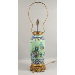 A VERY LARGE CHINESE GREEN GROUND FAMILLE ROSE PORCELAIN VASE / LAMP with ormolu mounted base,