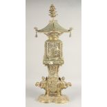 A TALL EAST ASIAN FOUR-PIECE BRASS LANTERN, in the form of a bird cage upon a figural base of