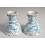 A PAIR OF CHINESE BLUE AND WHITE PORCELAIN CANDLESTICKS, possibly 1900, painted with dragons and