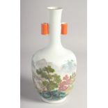 A CHINESE FAMILLE ROSE TWIN HANDLE VASE, painted with a mountainous landscape, the base with six-