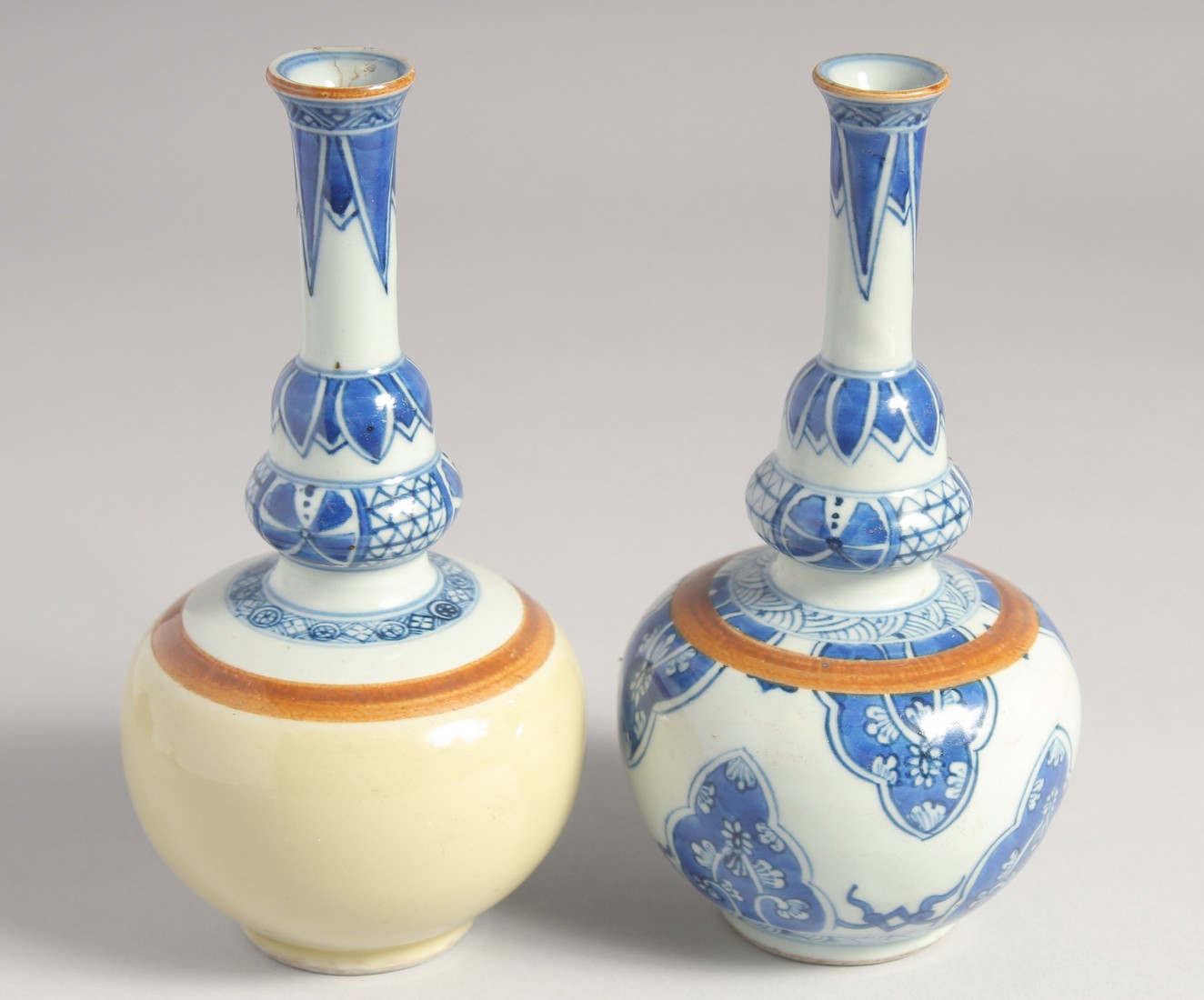 TWO SMALL CHINESE BLUE AND WHITE PORCELAIN VASES, each 17cm high.