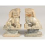 A PAIR OF CARVED SEATED TEMPLE LIONS. 7" high