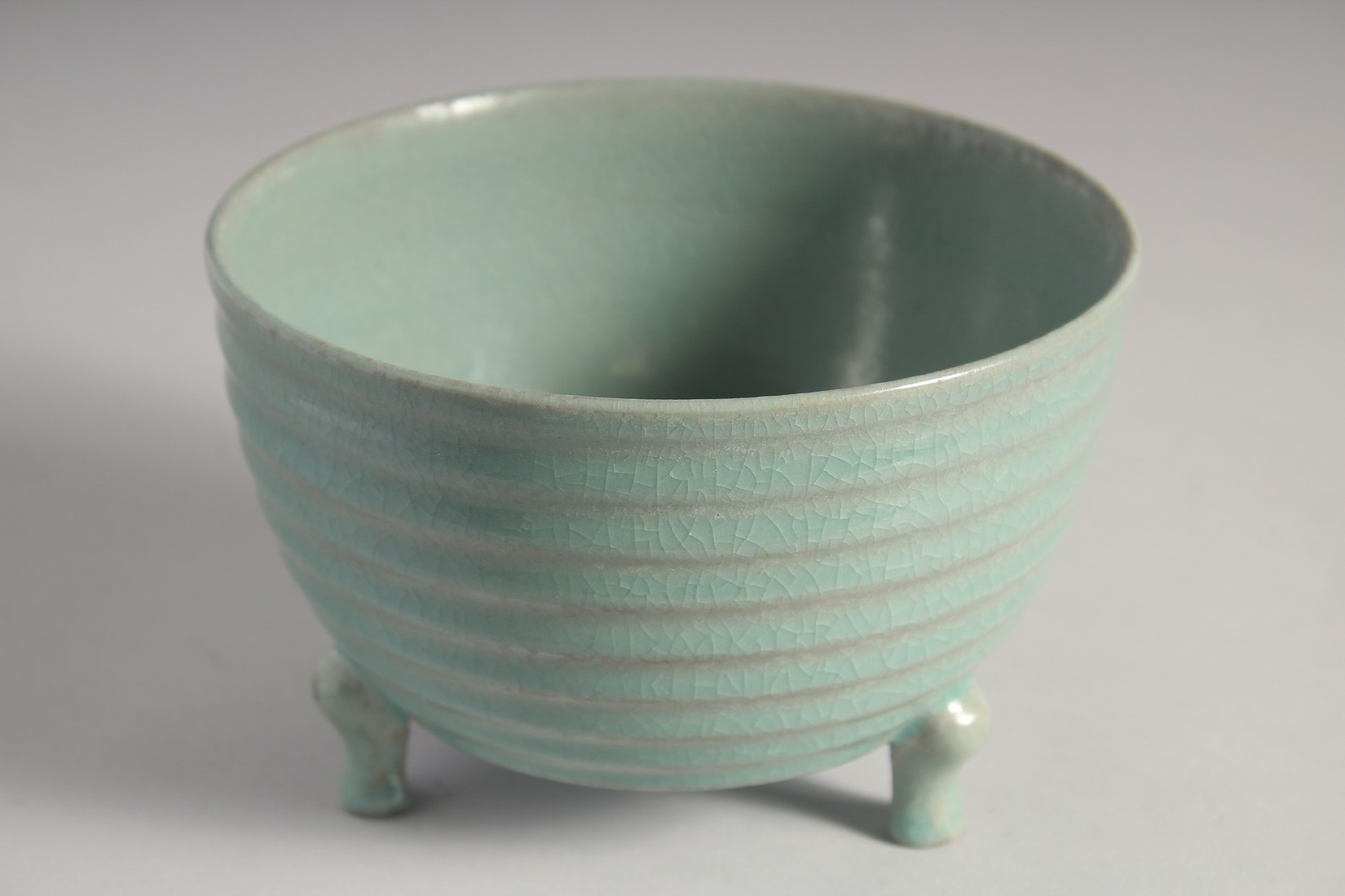 A CHINESE CELADON PORCELAIN TRIPOD CENSER with bronze stand, the base with carved characters. 15.5cm - Image 4 of 9