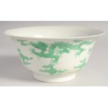 A CHINESE PORCELAIN DRAGON BOWL, the exterior with carved dragon and cloud decoration in green, 19.