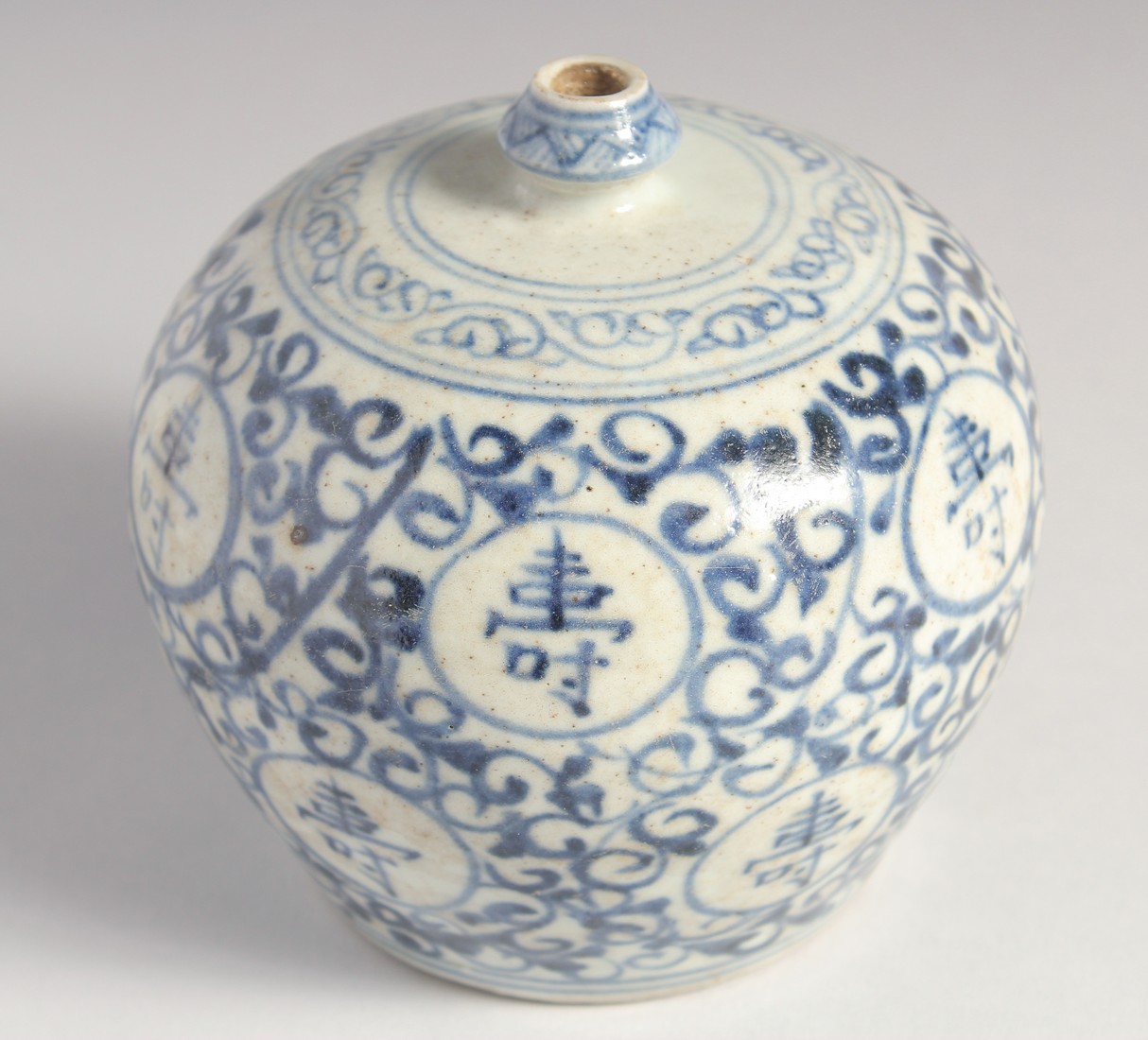 A SMALL CHINESE BLUE AND WHITE PORCELAIN BULBOUS VASE, painted with characters, 11.5cm high.