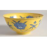 A CHINESE IMPERIAL YELLOW GROUND BLUE AND WHITE PORCELAIN BOWL painted with flower heads, the base