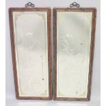 A LARGE PAIR OF CHINESE CARVED HARDWOOD FRAMED MIRRORS, the glass with engraved decoration depicting