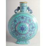 A VERY LARGE CHINESE TURQUOISE GROUND PORCELAIN TWIN HANDLE MOON FLASK VASE, decorated with bajixing