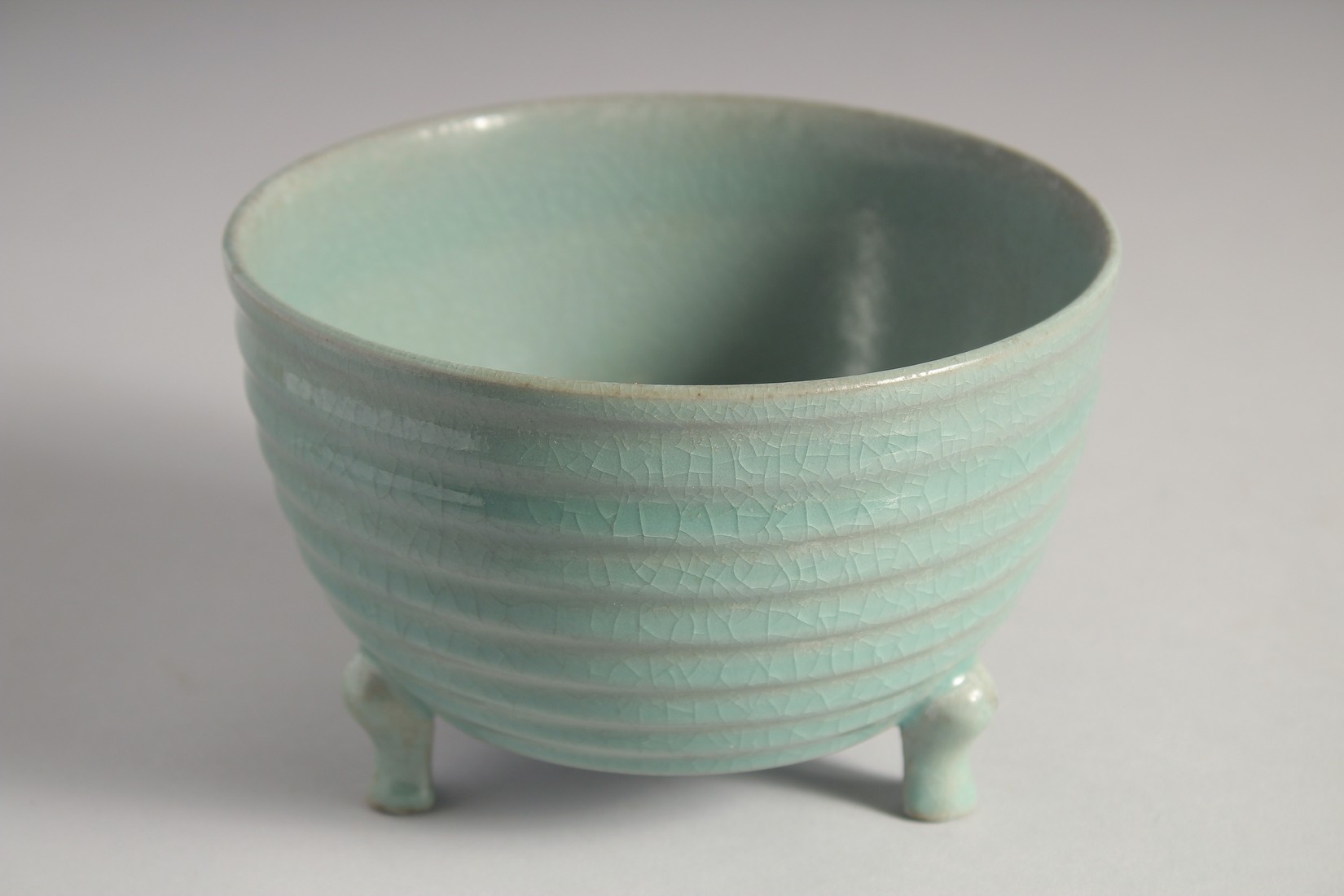 A CHINESE CELADON PORCELAIN TRIPOD CENSER with bronze stand, the base with carved characters. 15.5cm - Image 2 of 9