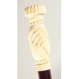 A CARVED BONE HANDLE WALKING STICK "CLASPED HANDS".