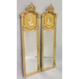 A PAIR OF FRENCH STYLE GILTWOOD TALL DRESSING MIRRORS, the upper panels moulded with the busts of