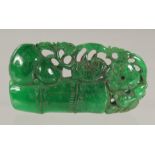 A CHINESE CARVED GREEN JADE PENDANT.