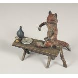 A SMALL VIENNA BRONZE GROUP OF A FOX COOKING. 8.25ins long.