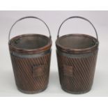 A GOOD PAIR OF GEORGIAN STYLE "IRISH PEAT BUCKETS" with wraths, fluted bodies, swing handles and