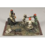 AN AUSTRIAN PAINTED COLD CAST GROUP, boys playing. 7.5ins long.