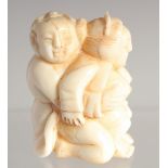 A CARVED BONE EROTIC NETSUKE. 1.5ins long.