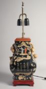 A CHINESE FAMILLE NOIRE LAMP decorated with calligraphy and figures converted to electricity on a