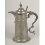 A LARGE PEWTER LIDDED JUG. 13ins high.