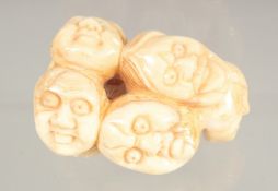 A CARVED BONE FACES INRO.