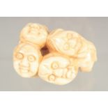 A CARVED BONE FACES INRO.