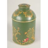 A GREEN TOLEWARE TEA TIN AND COVER. 15ins high.