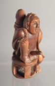 AN EROTIC CARVED WOOD NETSUKE. 2.25ins