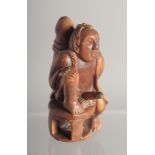 AN EROTIC CARVED WOOD NETSUKE. 2.25ins