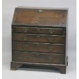 A GEORGE III OAK BUREAU with front fitted interior, four long graduated drawers on bracket feet. 3ft
