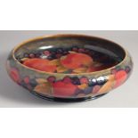 WILLIAM MOORCROFT CIRCULAR POMEGRANATE CIRCULAR BOWL. circa. 1925. W. M. script in blue,