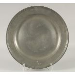 AN EARLY PEWTER CIRCULAR DISH. 14.5ins diameter.