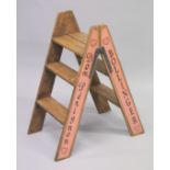 A PAIR OF NOVELTY PINE CHAMPAGNE STEPS. 34ins high.