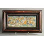 AN EARLY MAJOLICA PLAQUE, POSSIBLY 15TH -16TH CENTURY. A battle scene 7ins x 18ins frame (A/F).