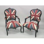 A PAIR OF EBONISED OPEN ARMCHAIRS upholstered with a Union Jack flag fabric.