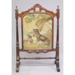 A GOOD VICTORIAN MAHOGANY FIRE SCREEN with a Brussels needlework panel of two dogs, with glazed