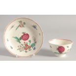 A LIVERPOOL TEA BOWL AND SAUCER painted with oriental style coloured flowers.