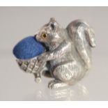 A SILVER SQUIRREL PIN CUSHION.