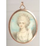 AN 18TH CENTURY OVAL PORTRAIT MINIATURE OF A LADY with blue enamel back. 2.25ins x 2.25ins.