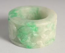 A CHINESE CARVED JADE RING. 2.25ins diameter.