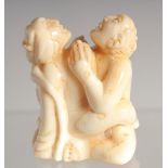 A CARVED BONE EROTIC NETSUKE. 1.5ins long.